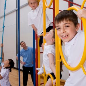 Primary school students using a climbing frame