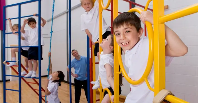 Primary school students using a climbing frame