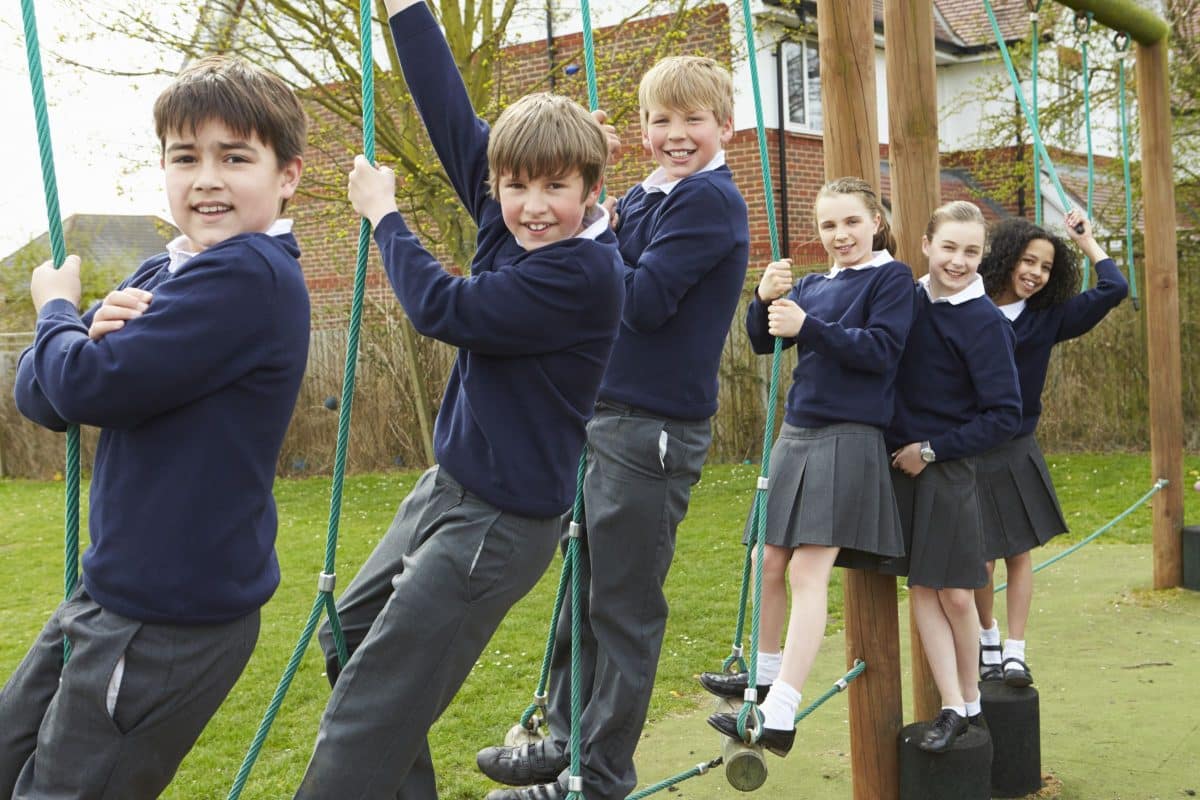 Children using outdoor climbing equipment