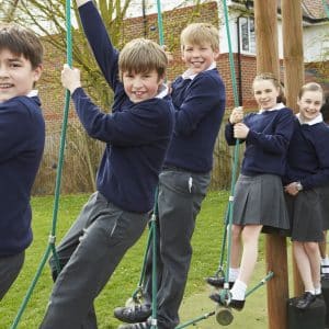 Children using outdoor climbing equipment