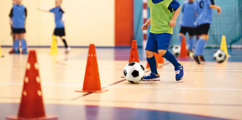 Children playing football inside