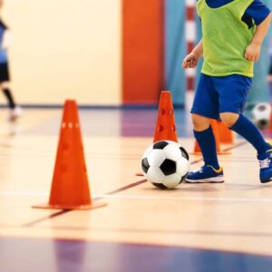 Children playing football inside