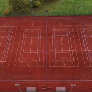 Red MUGA with basketball markings painted on
