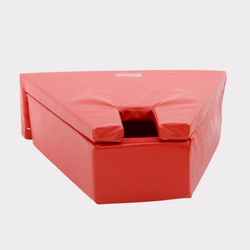 Red triangular soft play shape with a notch on one side. Made of padded material, it suggests safety and fun in play environments for children.