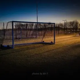 Football goal on artificial grass with unrise