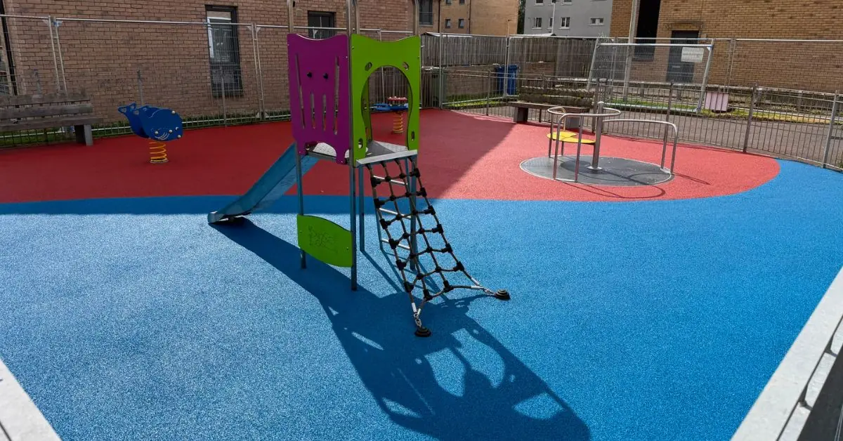 Resurfaced blue and red play park surfacing