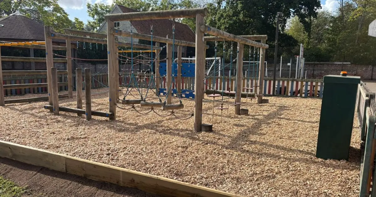 Wooden Play Tower with bark surrounding it